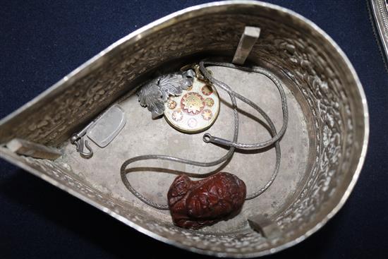 A Burmese silver teardrop shaped box with pierced cover containing minor items of jewellery.